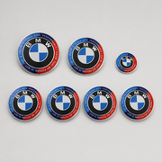 Seven-piece red and blue anniversary-style replacement emblem set compatible with BMW