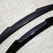 Close-up comparison of carbon look and gloss black BMW 5 Series rear boot spoilers