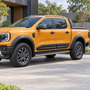 Orange Ford Ranger T9 fitted with matte-black lower side door mouldings