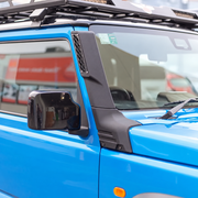 Black raised air intake snorkel fitted to a blue Suzuki Jimny