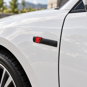 Aftermarket S-line-style badge installed on white car fender